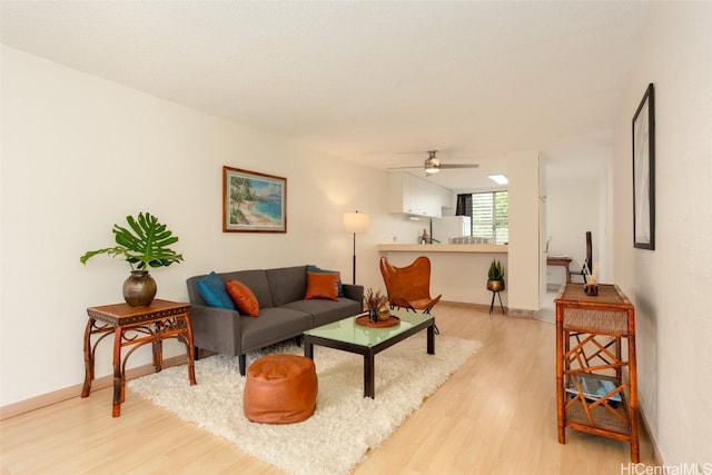 living room with light wood-type flooring and ceiling fan