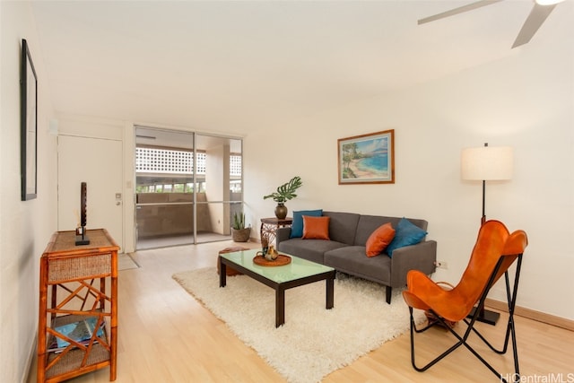 living room featuring light hardwood / wood-style floors and ceiling fan