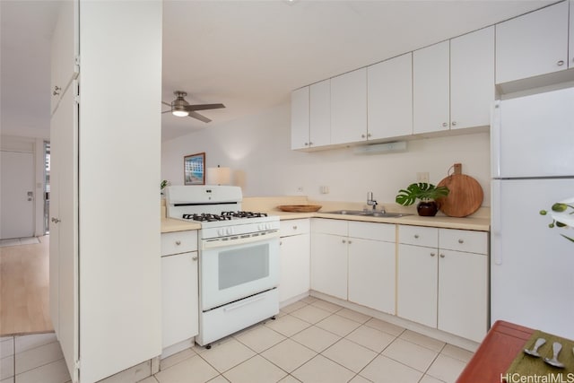 kitchen with sink, white cabinets, white appliances, and ceiling fan