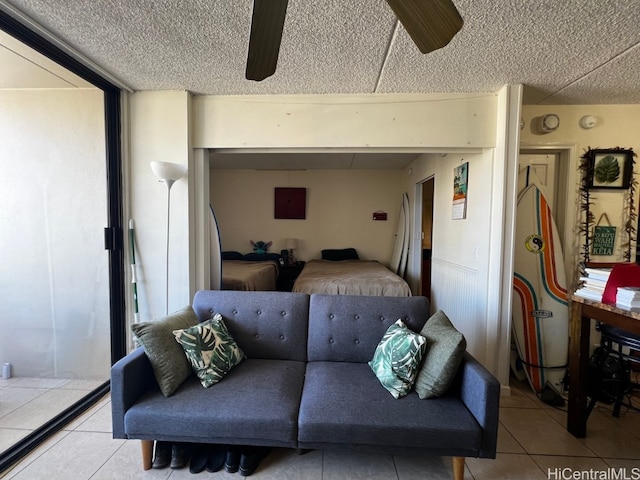 tiled living room featuring a textured ceiling and ceiling fan