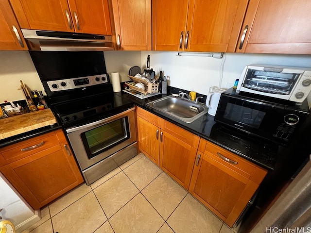 kitchen featuring stainless steel electric stove, sink, and light tile patterned floors