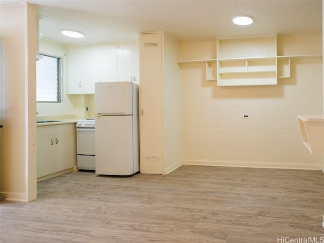 kitchen with light wood-type flooring and white appliances