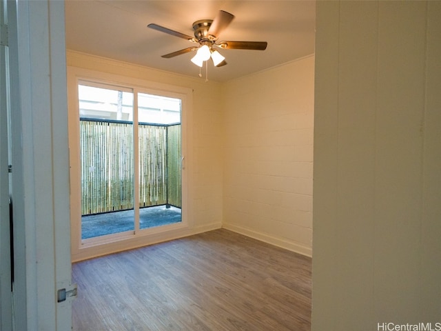 spare room featuring ceiling fan, hardwood / wood-style flooring, and crown molding