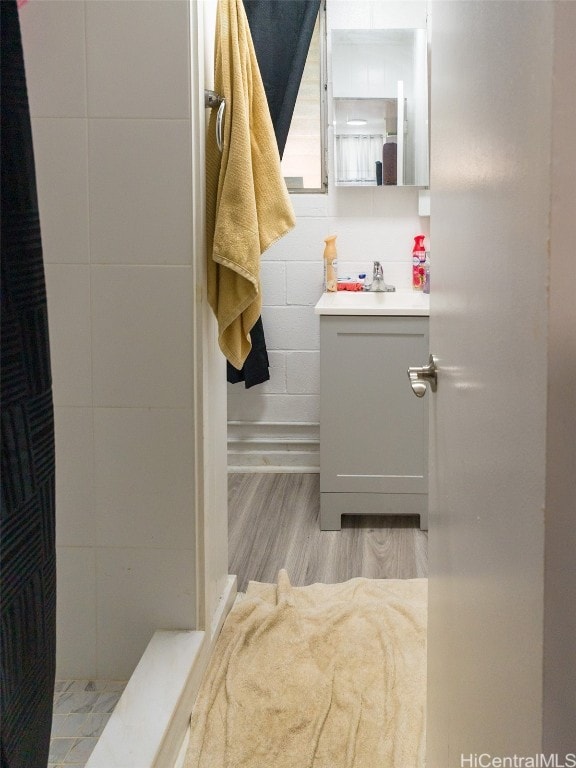 bathroom with vanity and hardwood / wood-style flooring