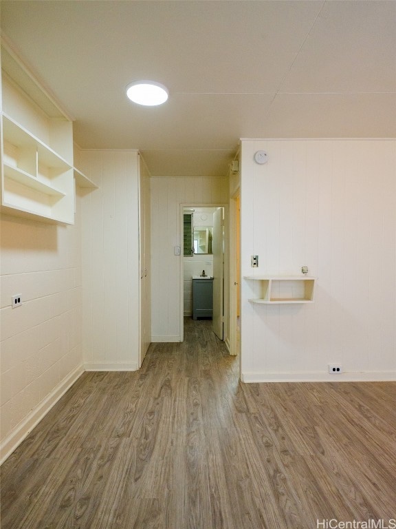 laundry area with wood-type flooring