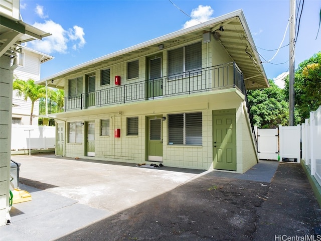 view of front of property with a patio area and a balcony