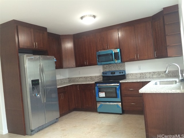 kitchen with sink, appliances with stainless steel finishes, and dark brown cabinetry