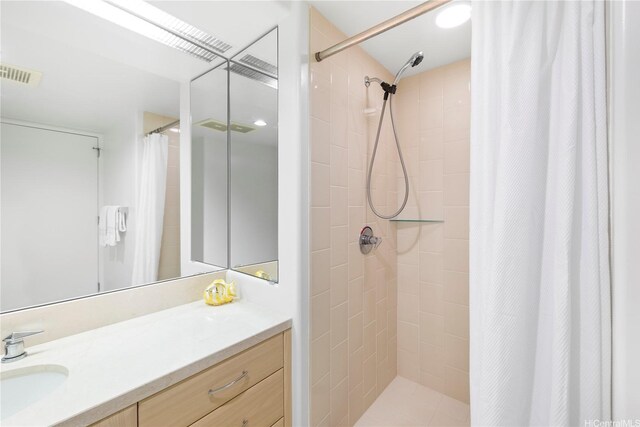 88 Piikoi St Unit 1405, Honolulu, HI 96814 - bathroom featuring vanity and a tile shower