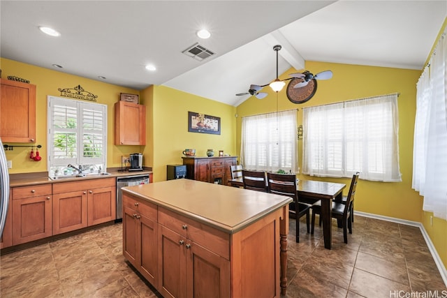 kitchen featuring vaulted ceiling with beams, dishwasher, a healthy amount of sunlight, and a center island