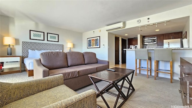 carpeted living room with a wall unit AC and rail lighting