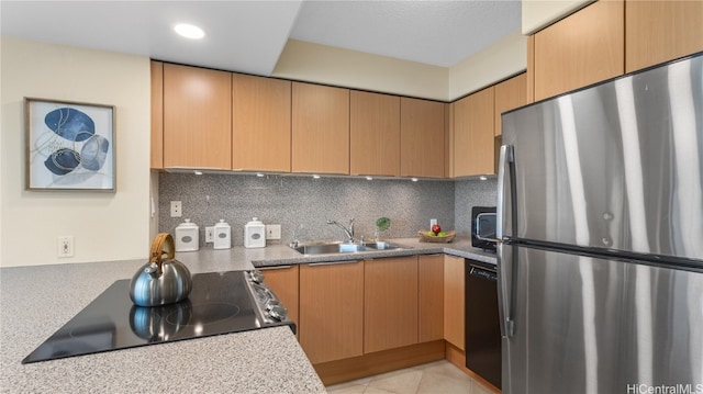 kitchen with sink, black appliances, backsplash, and light tile patterned floors