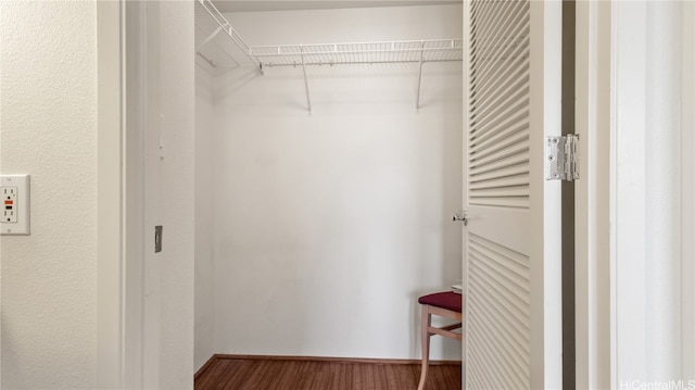 walk in closet featuring hardwood / wood-style floors