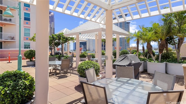 view of patio / terrace featuring a balcony, a grill, and a pergola