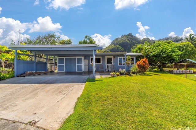 single story home with a carport and a front lawn