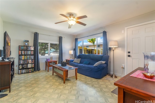 living room with crown molding, a healthy amount of sunlight, light parquet flooring, and ceiling fan