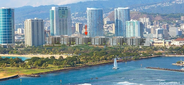 property's view of city with a water and mountain view