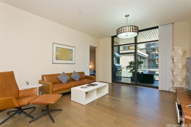 living room with hardwood / wood-style flooring and a wall of windows