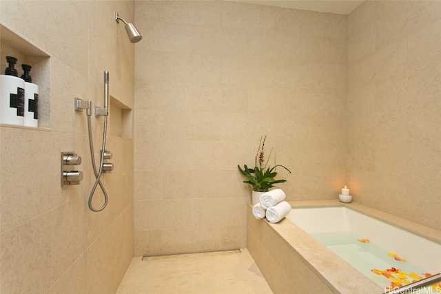 bathroom with separate shower and tub and tile patterned floors