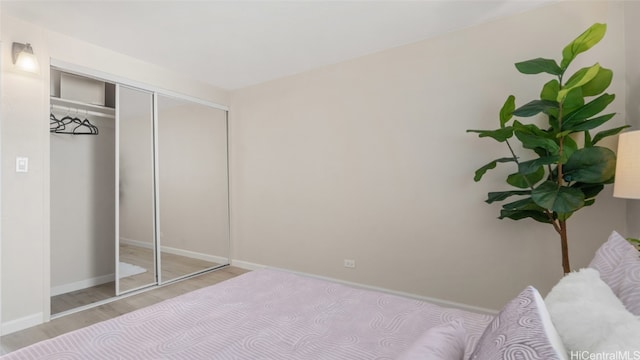 bedroom with a closet and light wood-type flooring