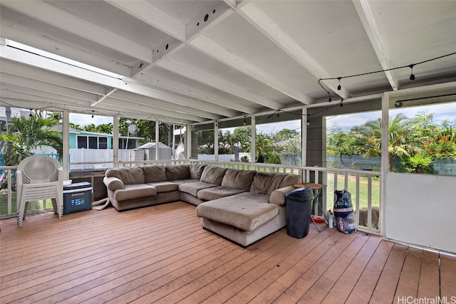 sunroom / solarium featuring beam ceiling