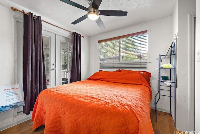 bedroom with a textured ceiling, access to exterior, wood-type flooring, and ceiling fan