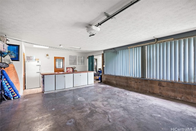 garage featuring white fridge