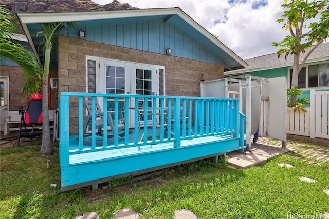 rear view of property with a yard and a wooden deck