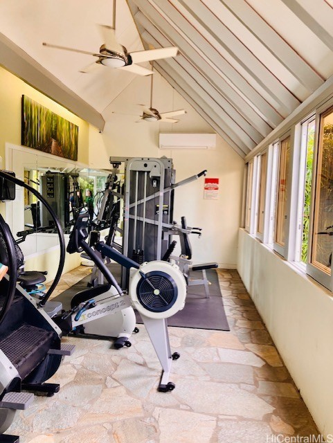 workout area featuring ceiling fan and high vaulted ceiling