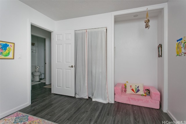 bedroom with dark hardwood / wood-style flooring