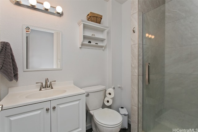 bathroom with vanity, toilet, and an enclosed shower