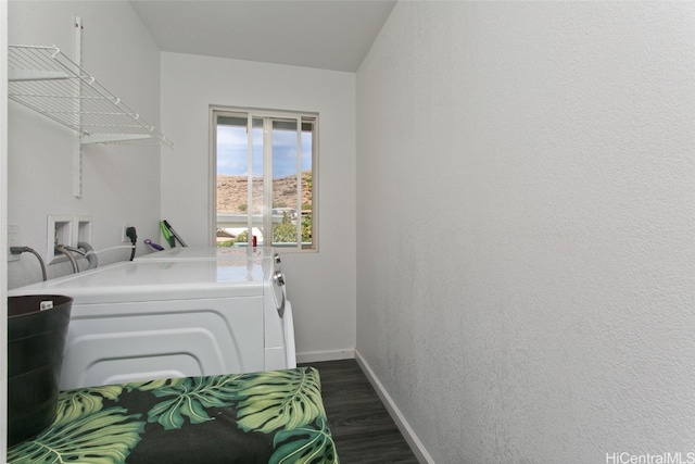 laundry area featuring dark wood-type flooring and washer and clothes dryer