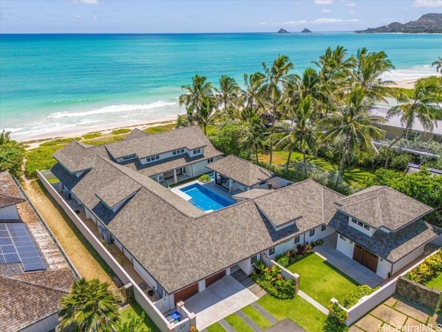 drone / aerial view with a water view and a beach view