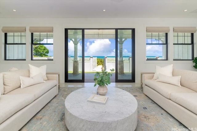 living room featuring a water view and plenty of natural light