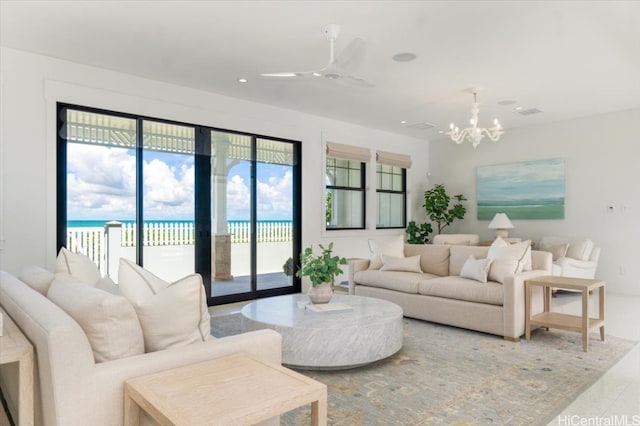 living room featuring a chandelier and a water view