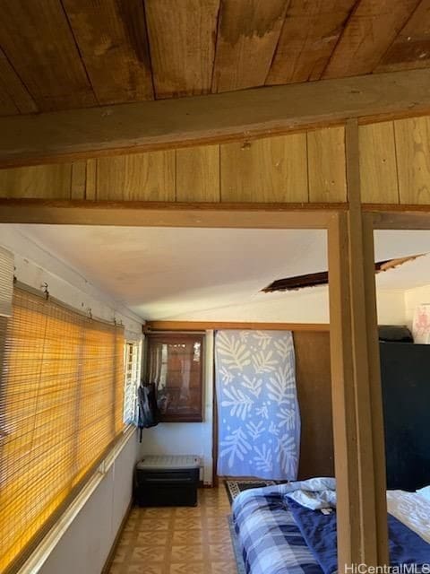 bedroom featuring beamed ceiling and wooden ceiling