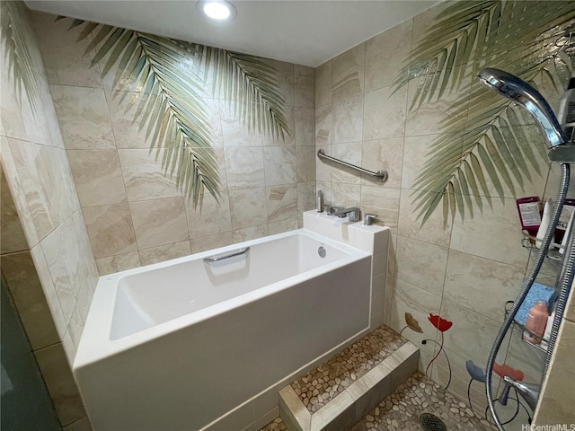 full bath featuring recessed lighting, tile walls, tiled shower, and a tub to relax in