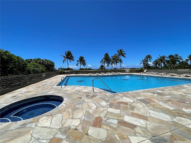 community pool with a patio and a community hot tub