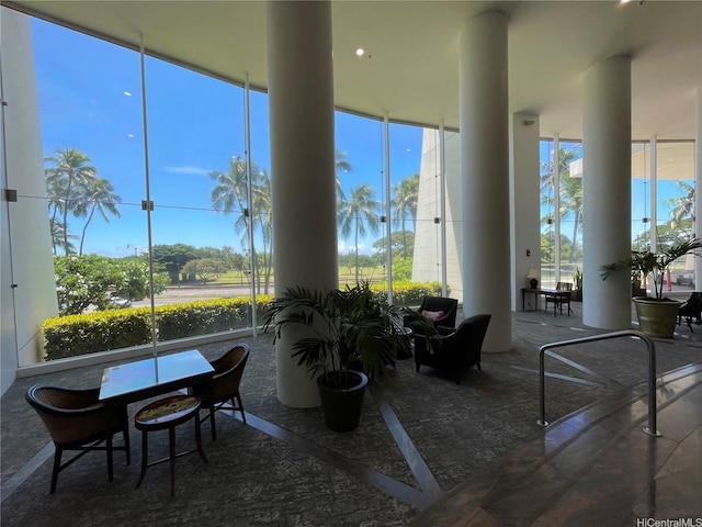 interior space featuring a healthy amount of sunlight and a wall of windows