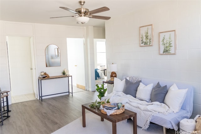 living room featuring ceiling fan and hardwood / wood-style flooring