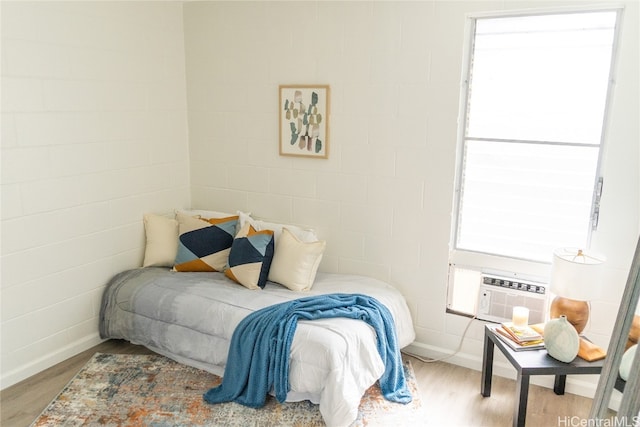 bedroom featuring light hardwood / wood-style flooring and multiple windows