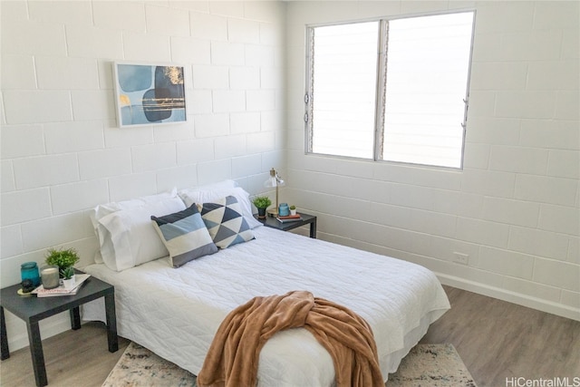 bedroom with wood-type flooring