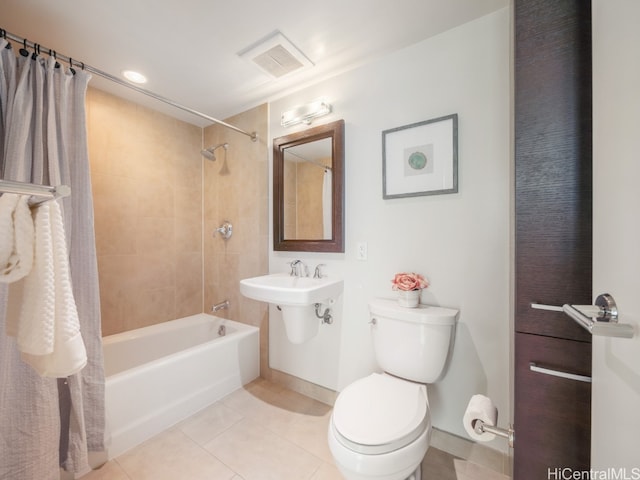 bathroom featuring shower / bathtub combination with curtain, toilet, and tile patterned flooring