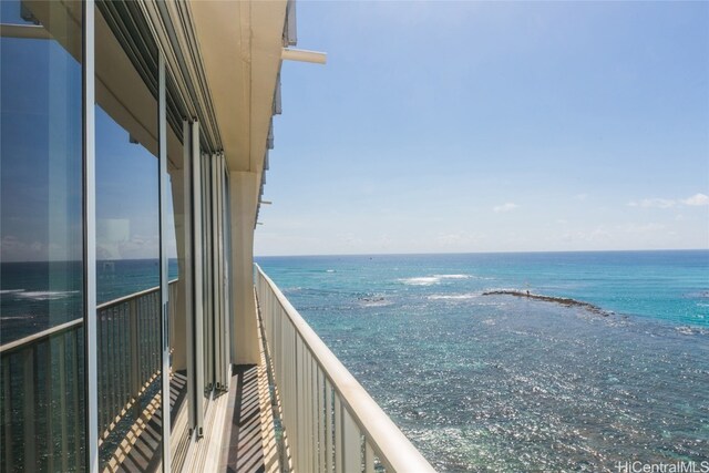 balcony featuring a water view and a view of the beach