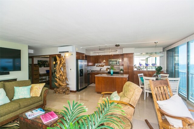 living room featuring a wall unit AC, a healthy amount of sunlight, and sink