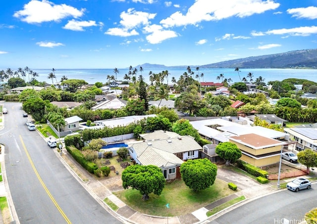 birds eye view of property with a water and mountain view