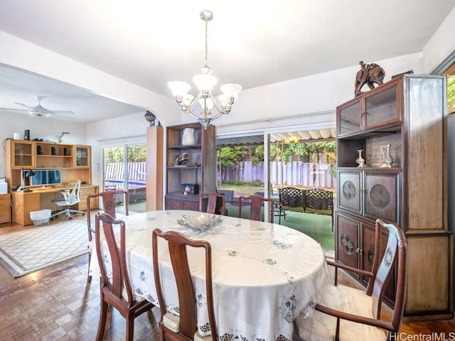 dining room featuring ceiling fan with notable chandelier