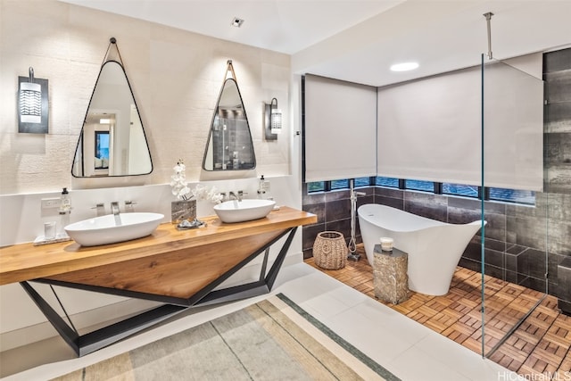 bathroom featuring tile walls, vanity, and shower with separate bathtub