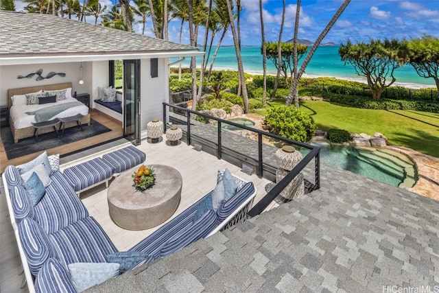 view of patio / terrace with a water view and a view of the beach