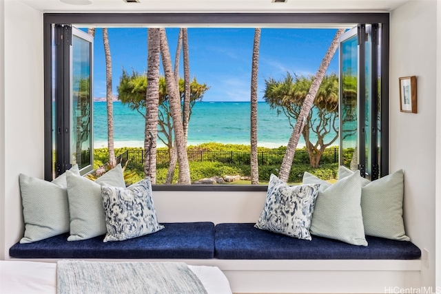 living area featuring a water view and a beach view