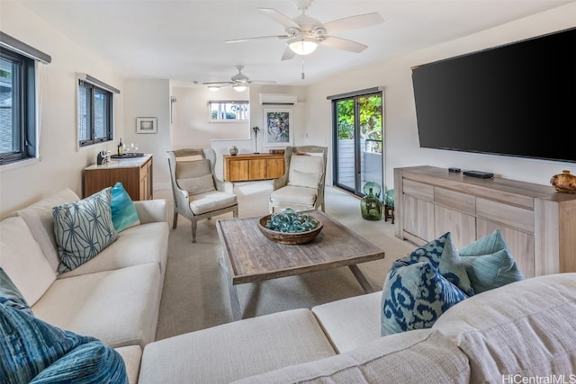 living room with ceiling fan, a wall mounted AC, a wealth of natural light, and light colored carpet